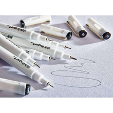 Fine line ink pens arranged with white bodies and black nib tips