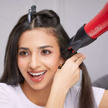 Red hair dryer being used to dry dark hair with a styling concentrator