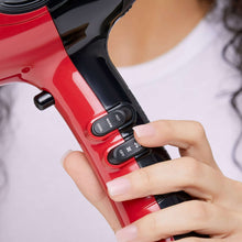 Red hair dryer handle with black control buttons for heat and speed