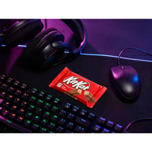 KIT KAT milk chocolate wafer candy bar in red wrapper on a desk