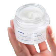 Hand holding KORRES Greek yoghurt nourishing gel-cream jar with white lid