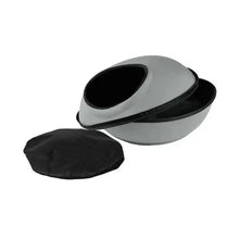 Gray round pod pet bed with dark oval opening and black cover cushion