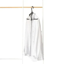 Kangaroo hanger holding a white shirt with curved hook and wide bar shoulders