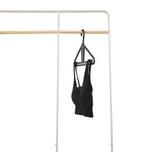 Black kangaroo hanger holding a dark garment bag