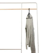 Gray kangaroo hanger holding a light knit garment