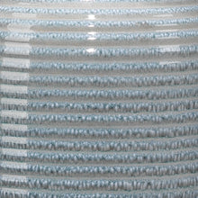 Table lamp base close-up: blue ribbed glass with silver metal top