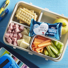Rice Krispies Treats snack bars with apple and carrot slices in a tray