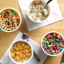Assorted cereal in bowls: multicolored ring cereal and yellow flake cereal mix