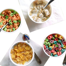Four bowls of cereal: multicolored rings, yellow flakes, and small frosted pieces