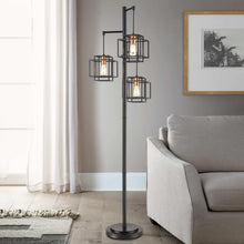 Black metal floor lamp with three square cage shades and clear Edison bulbs