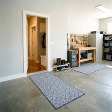 Gray-blue chevron runner rugs with border, placed on tile flooring