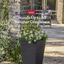 Graphite tapered resin planter outdoors with purple flowers and greenery