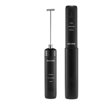 Black handheld milk frother with attached whisk and charging handle