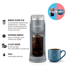 Gray iced and hot coffee maker with blue mug and tall iced coffee glass