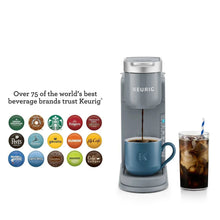 Gray Keurig K-Iced single-serve coffee maker dispensing coffee into a mug