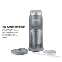 Gray single-serve coffee maker with iced-tumbler stand and clear lid accessory