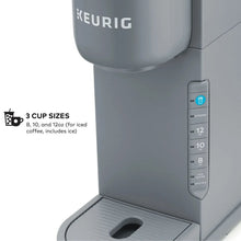 Gray single-serve coffee maker side view with cup-size selection panel