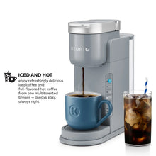 Gray single-serve iced and hot coffee maker with blue mug and iced cup