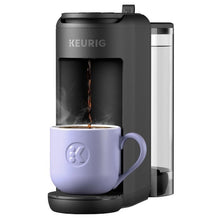Single-serve coffee maker pouring into lavender mug on base with water reservoir