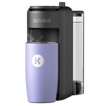 Single-serve coffee maker with lavender mug and lit brewing chamber