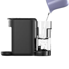 Single-serve coffee maker with water flowing from spout into cup