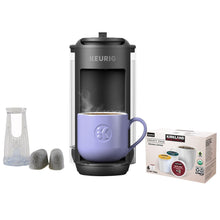 Keurig single-serve coffee maker with lavender mug, pods and water carafe accessories