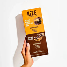 KiZE bar box held in hand: Peanut Butter Chocolate Chip and Cookie Dough