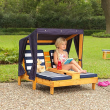 Kids double chaise lounge with canopy and striped cushions, girl seated