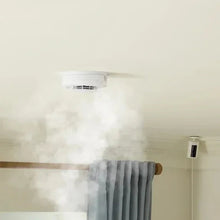 Hardwired smoke and carbon monoxide detector installed on ceiling near vent