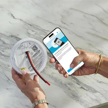 Smart smoke and carbon monoxide detector and smartphone showing status app