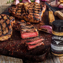 Kinder's The Blend seasoning salt jar on board near sliced grilled meat