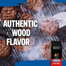Grill with charcoal briquettes and cooked food, with Kingsford bag at right