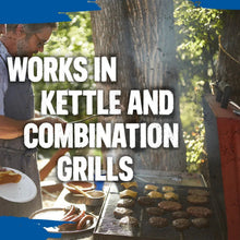 Charcoal briquettes on a grill grate with food cooking beside them