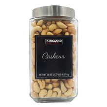 Glass canister of cashews with metal lid and front label