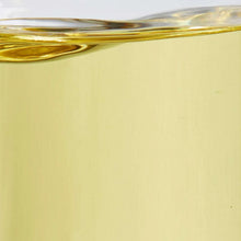 Canola oil container filled with amber liquid and smooth surface