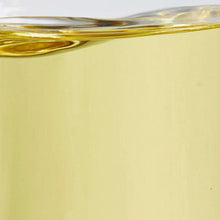 Yellow canola oil surface in a clear container