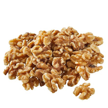 Walnut halves and pieces pile of light and dark brown kernels