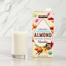 Organic unsweetened almond beverage carton with vanilla beside a filled glass