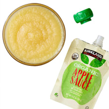 Organic apple sauce cup and green-capped pouch showing smooth yellow puree