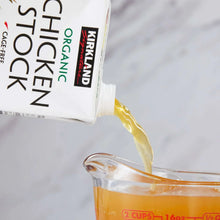 Kirkland Signature organic chicken stock pour into measuring cup