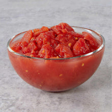 Bowl of diced organic tomatoes, red chunky pieces with visible juice