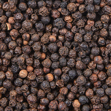 Whole black peppercorns close-up, dark pods with brown tips