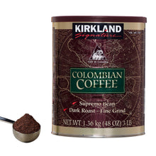 Dark roast coffee can with scoop of grounds beside it