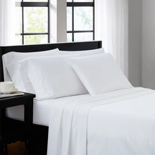 White sheet set on a bed with headboard and pillows