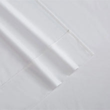 Close-up of white sheet fabric with stitched seams and folds