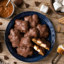 Chocolate-coated caramel s'mores clusters, including cut pieces showing the filling