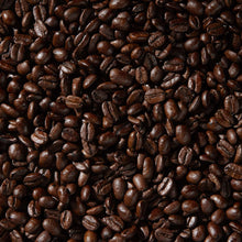 Whole coffee beans, dark brown, filling the frame