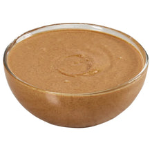 Bowl of creamy almond butter with a smooth, light brown surface