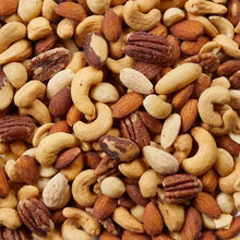 Mixed salted nuts assortment in a close-up, cashews, almonds, and pecans
