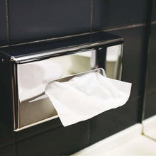 Facial tissues in dispenser, white tissues pulled through front opening